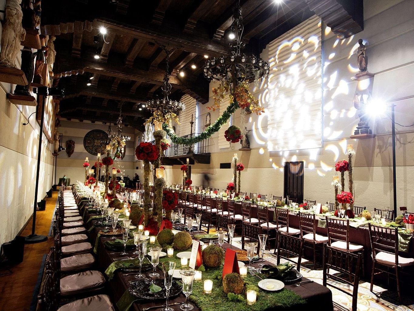 ballroom with long tables and flower/moss centerpieces