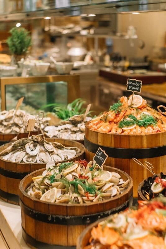 Seafood display featuring wooden bowls filled with shrimp, clams, and oysters in Opera Sunday Brunch at Park Hyatt Saigon