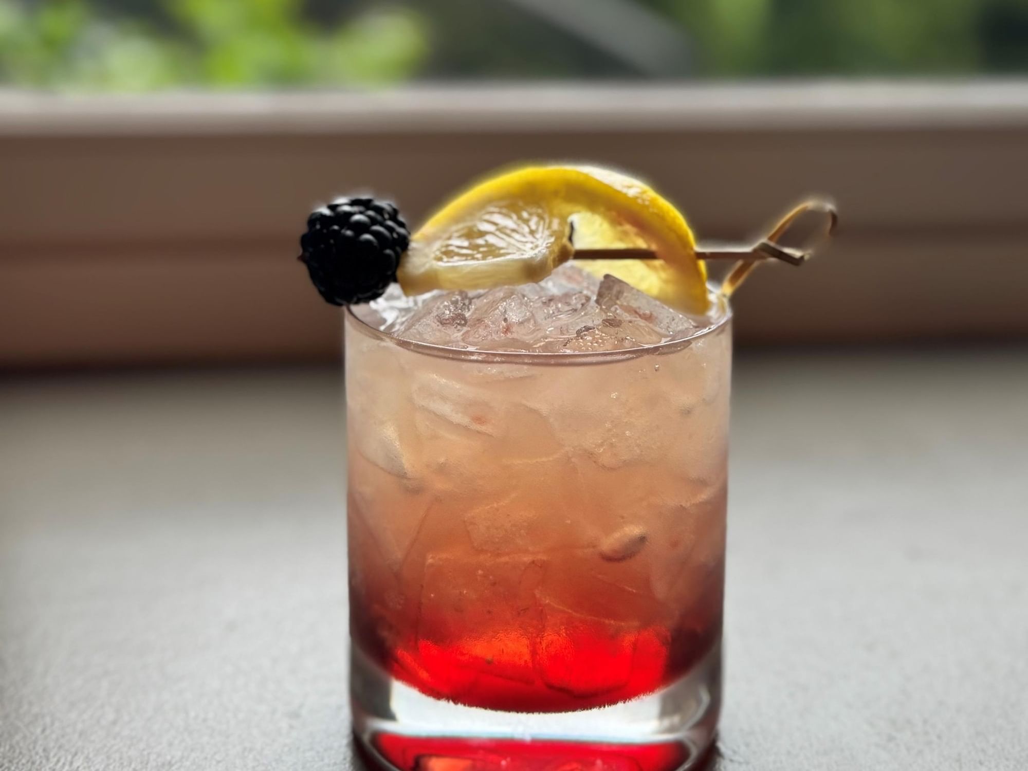 Cocktail with lemon and blackberry garnish at The Abbey Inn & Spa in Peekskill.