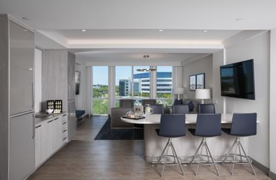 Interior with Barstools & TV in Parlor Room at Innovation Hotel