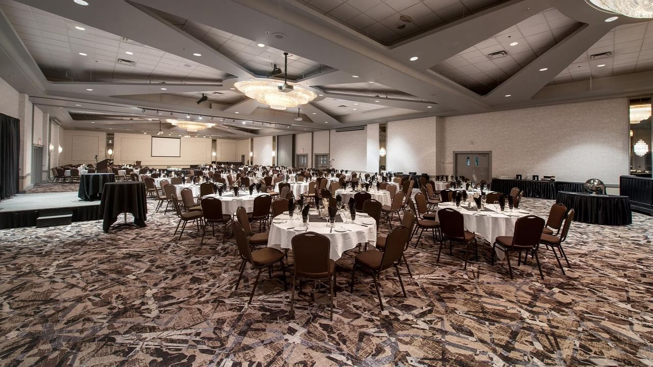 Ballroom with round tables and chairs set up for an event