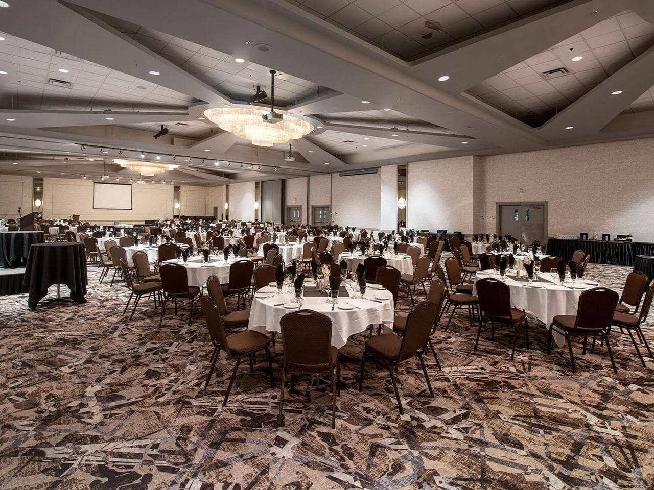 Ballroom with round tables and chairs set up for an event