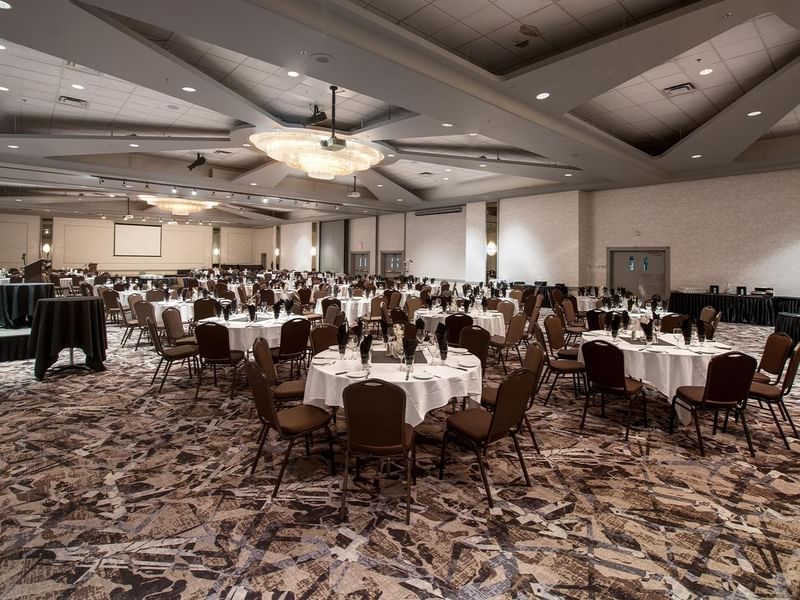 Ballroom with round tables and chairs set up for an event