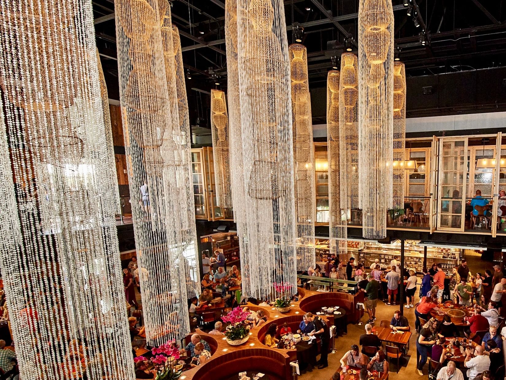 A large dining area with high ceilings and chandeliers