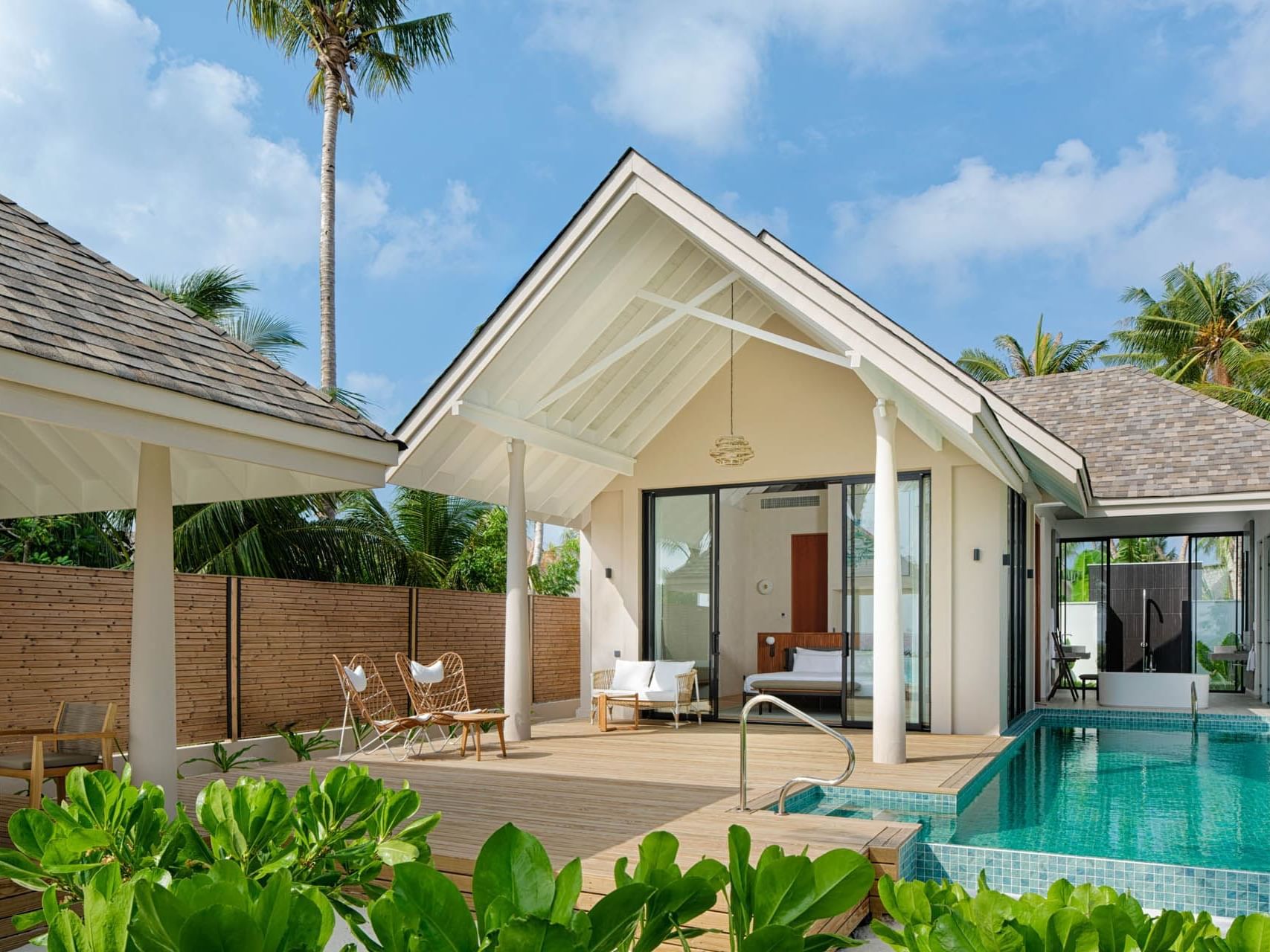 Exterior view of Deluxe Beach Pool Villa, surrounded by lush greenery and palm trees at Ananea Madivaru Maldives