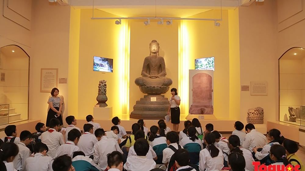 Children sitting by a statue in History Museum near Sunway Hotel Hanoi