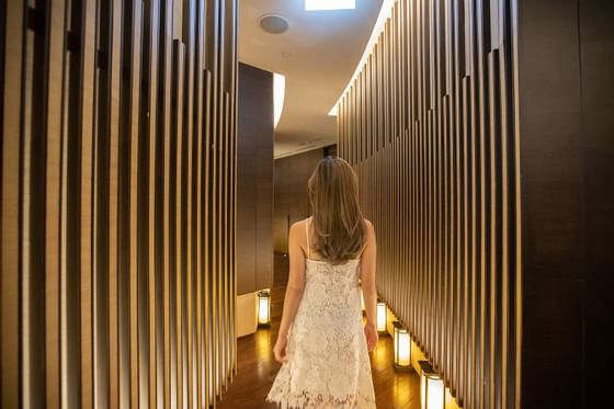 A girl walking to the spa at The Okura Prestige Bangkok