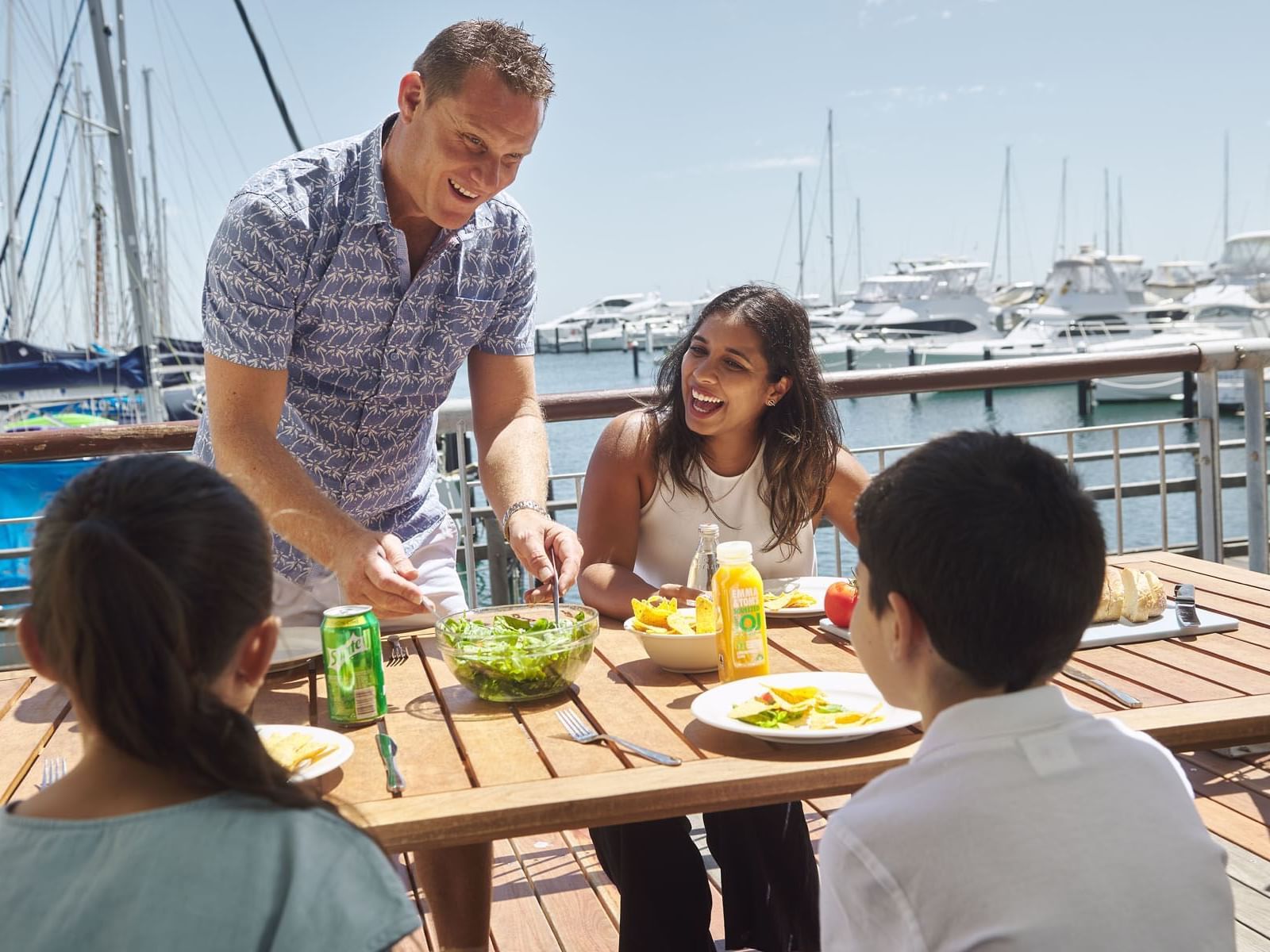 A family dining at the pier by the beach near Be Fremantle
