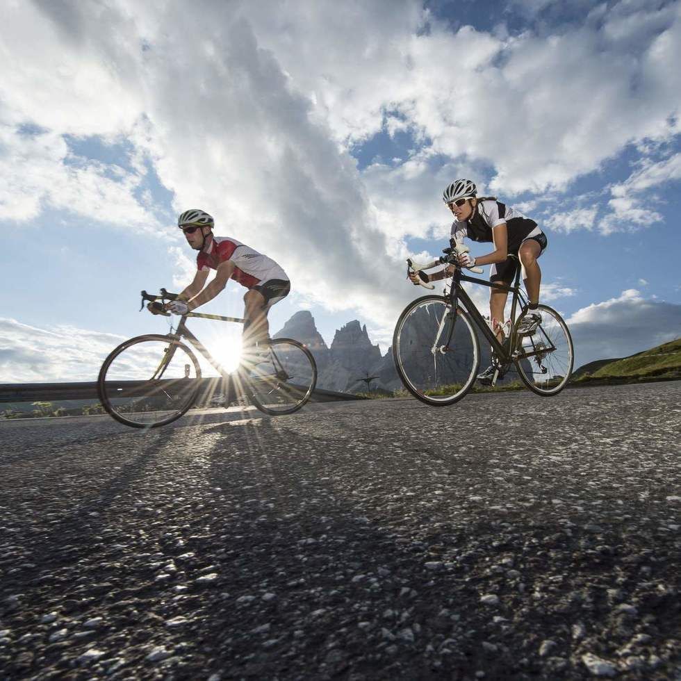 Low-angle shot of 2 bikers on a road near Falkensteiner Hotels