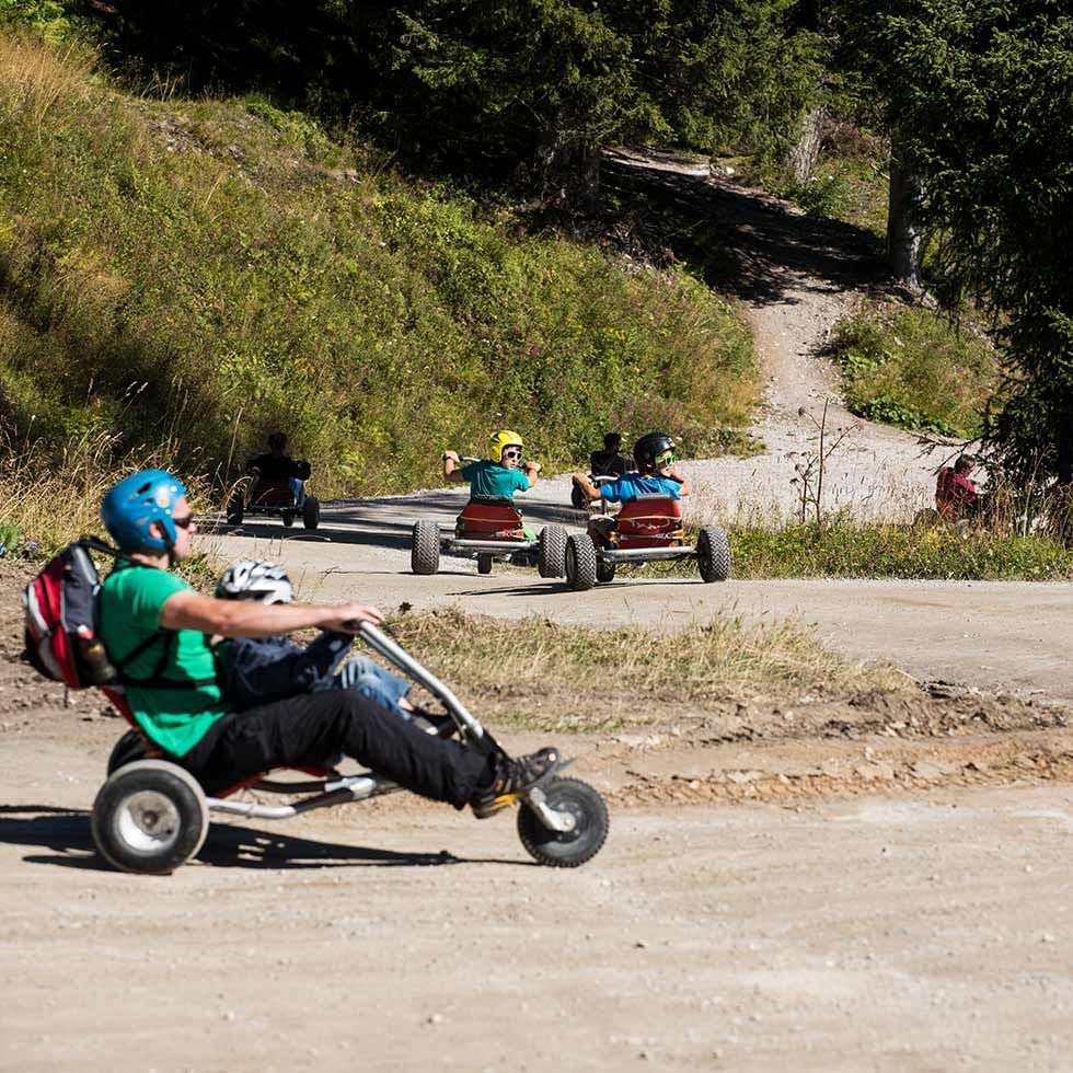 People riding go-karts near Falkensteiner Hotels