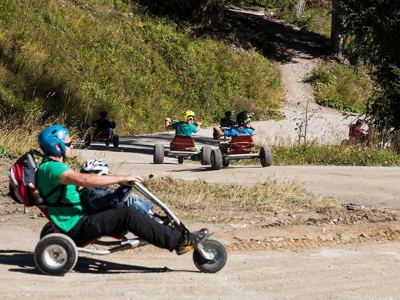 People riding go-karts near Falkensteiner Hotels