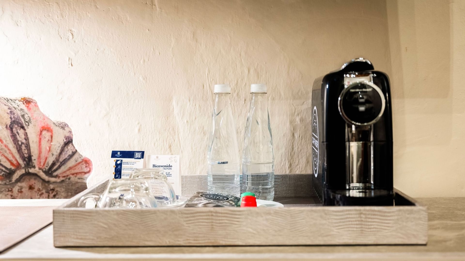 Tray with coffee machine, water bottles, and amenities in King Real room at Quinta Real Puebla, Heroica Puebla de Zaragoza.