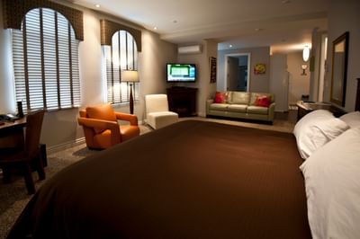 King bed, workspace & TV lounge area in Apartment 302 at Retro Suites Hotel