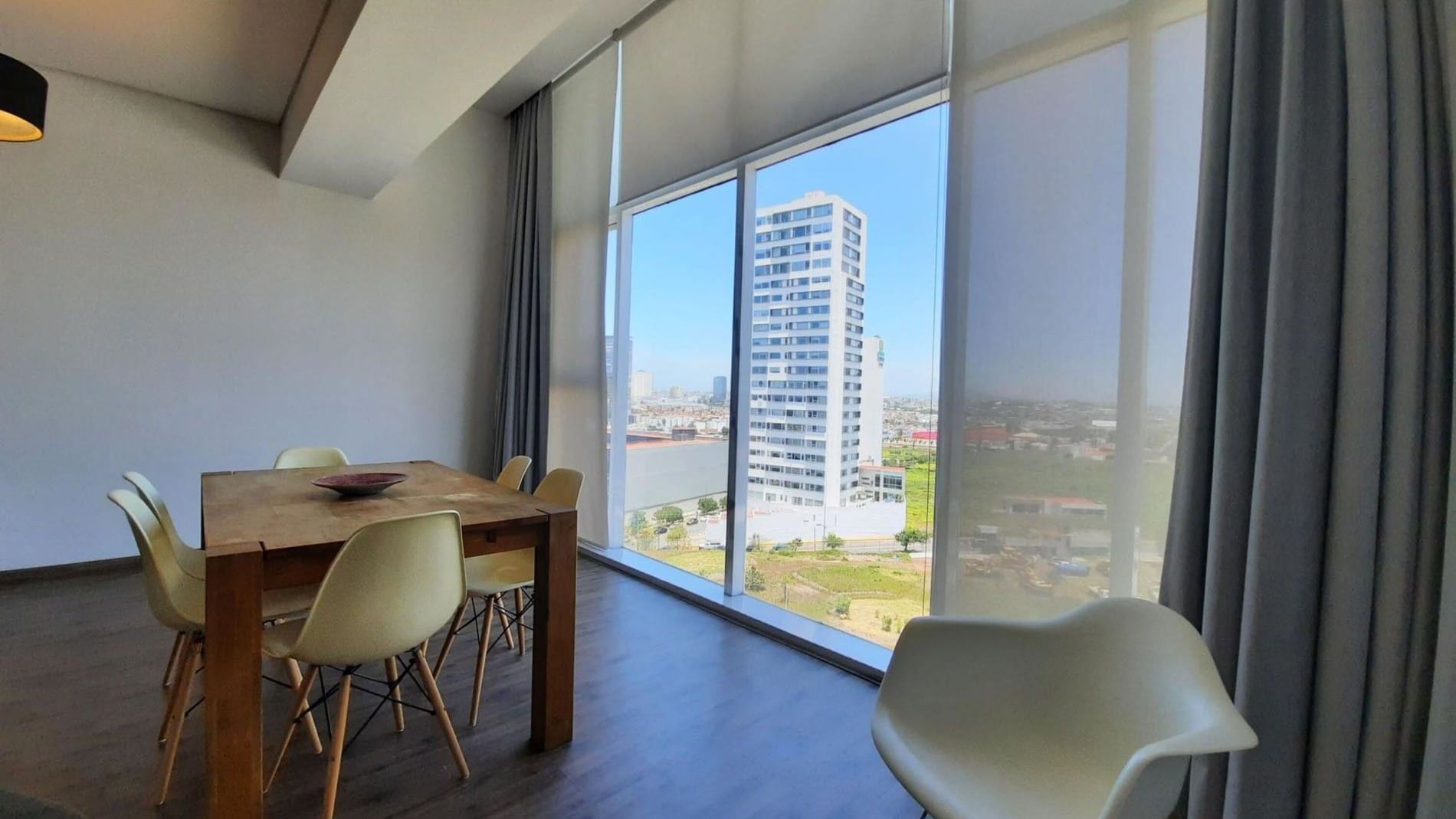 Dining area in King Bed and 2 Double Beds Suite 2 Rooms with floor-to-ceiling windows at Camino Real Puebla Angelopolis
