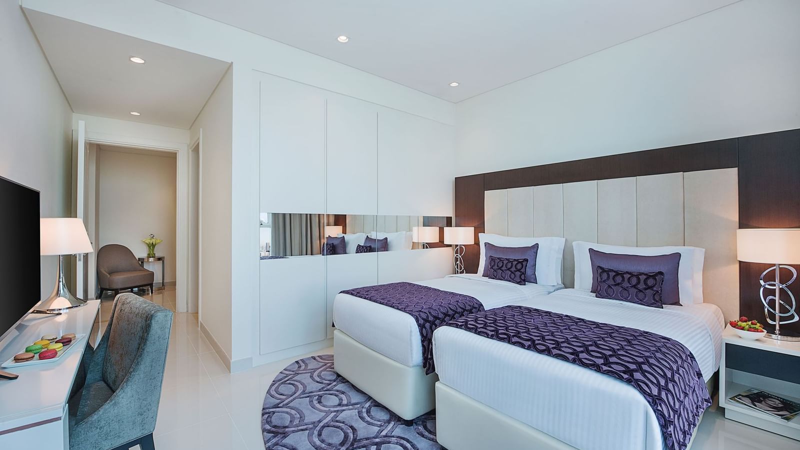 Twin beds by the wardrobe & a work desk space in Two Bedroom Suite at DAMAC Maison Distinction