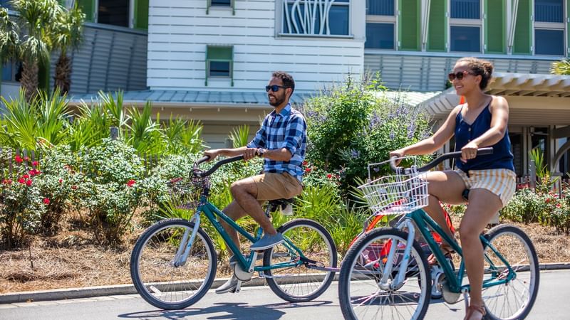 A couple riding bicycles at WaterColor Inn