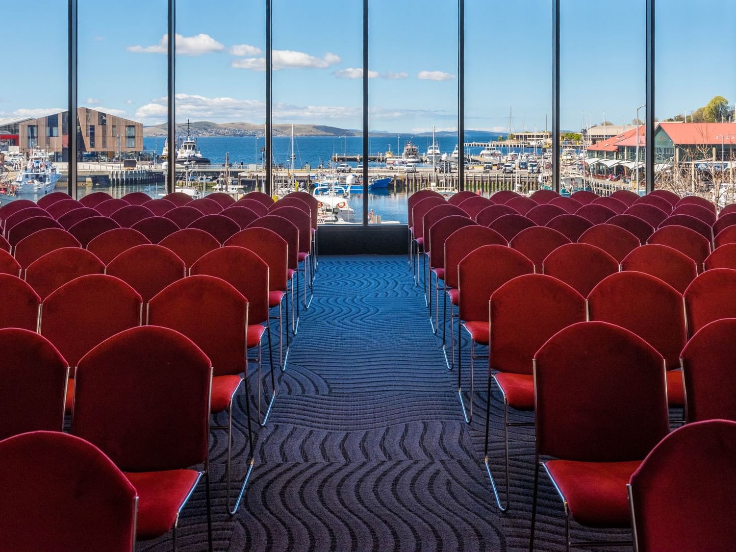 Harbour View Room One featuring theatre set-up with red chairs at Hotel Grand Chancellor Hobart