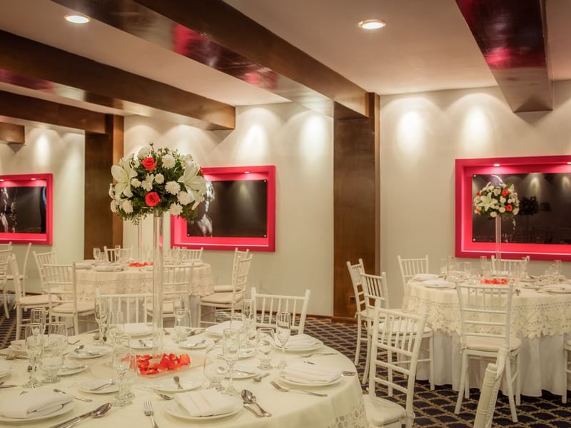 Banquet tables with floral decors at a wedding in Gamma Hotels
