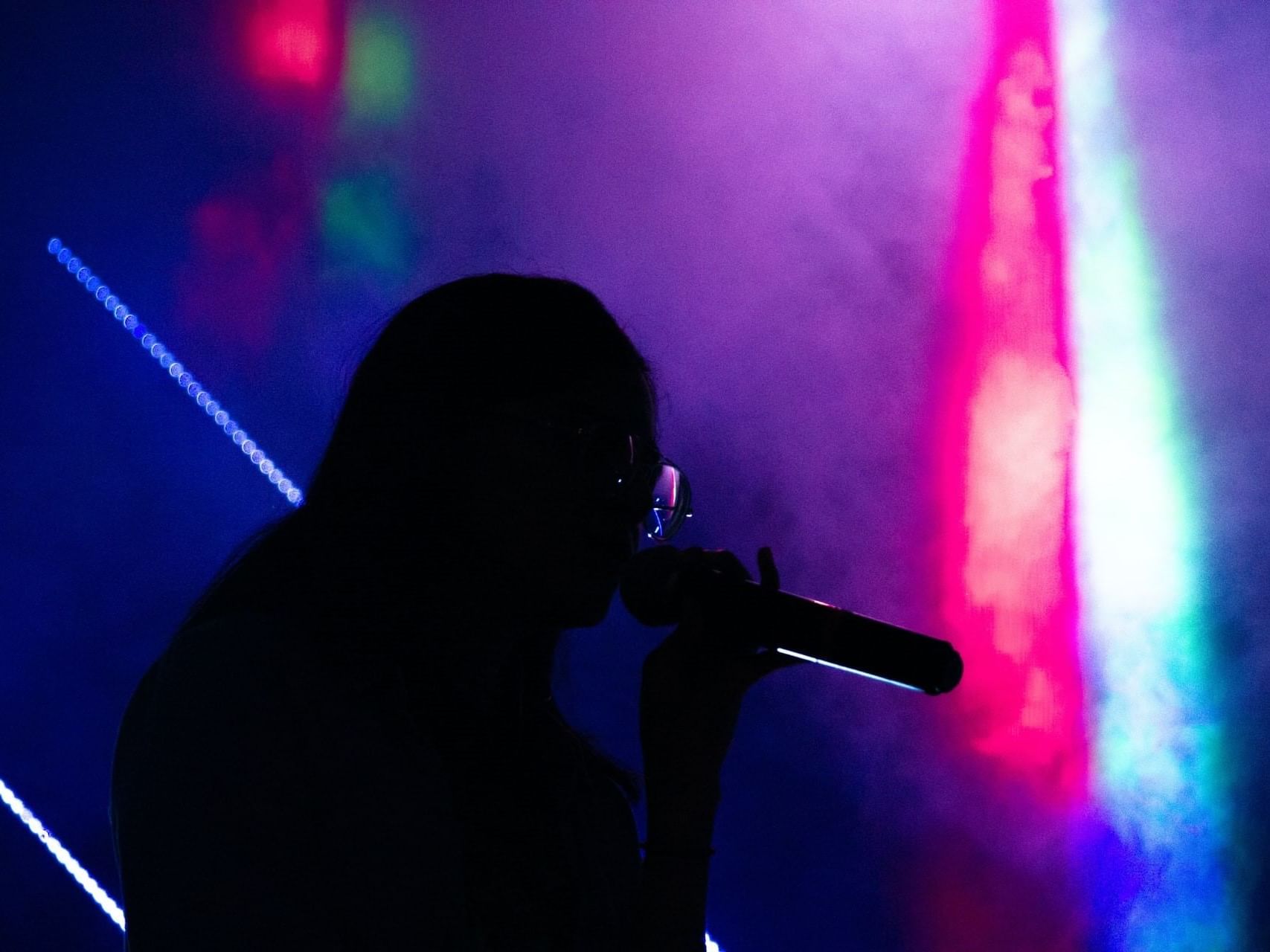 A performer performing in a concert at La Galerie Hotel