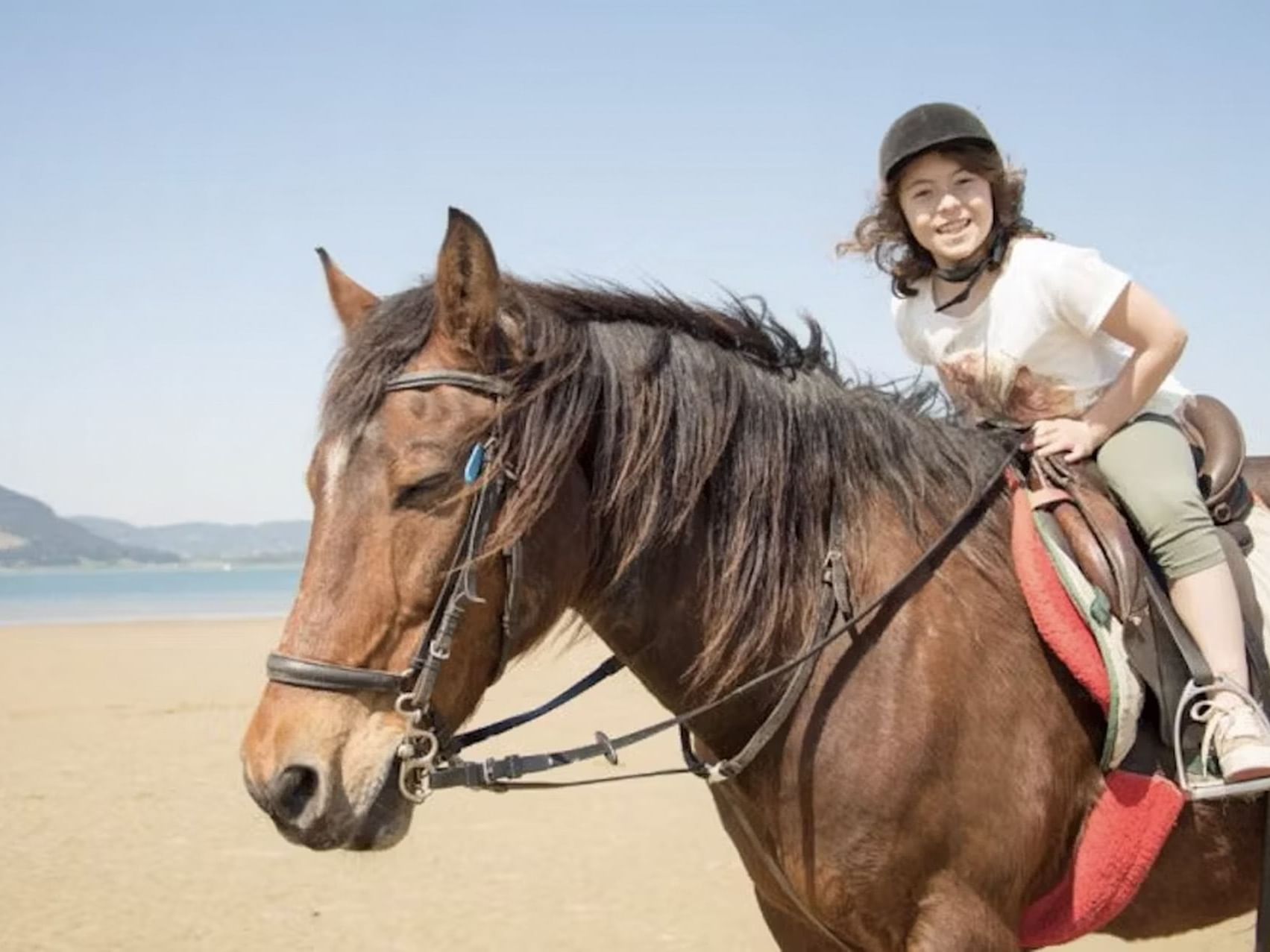 Child riding a horse at the beach near Las Olas Beach Resort featuring Panama day tours