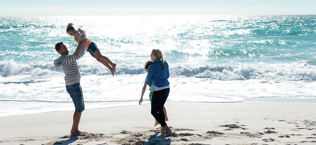 family having fun at the beach