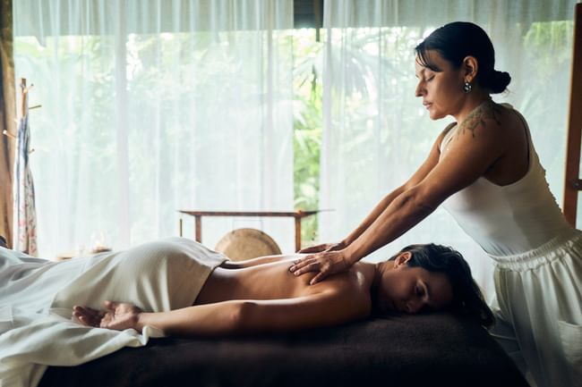 Relaxing back massage in Lahari Wellness Center, featuring garden views at Cala Luna Boutique Hotel spa
