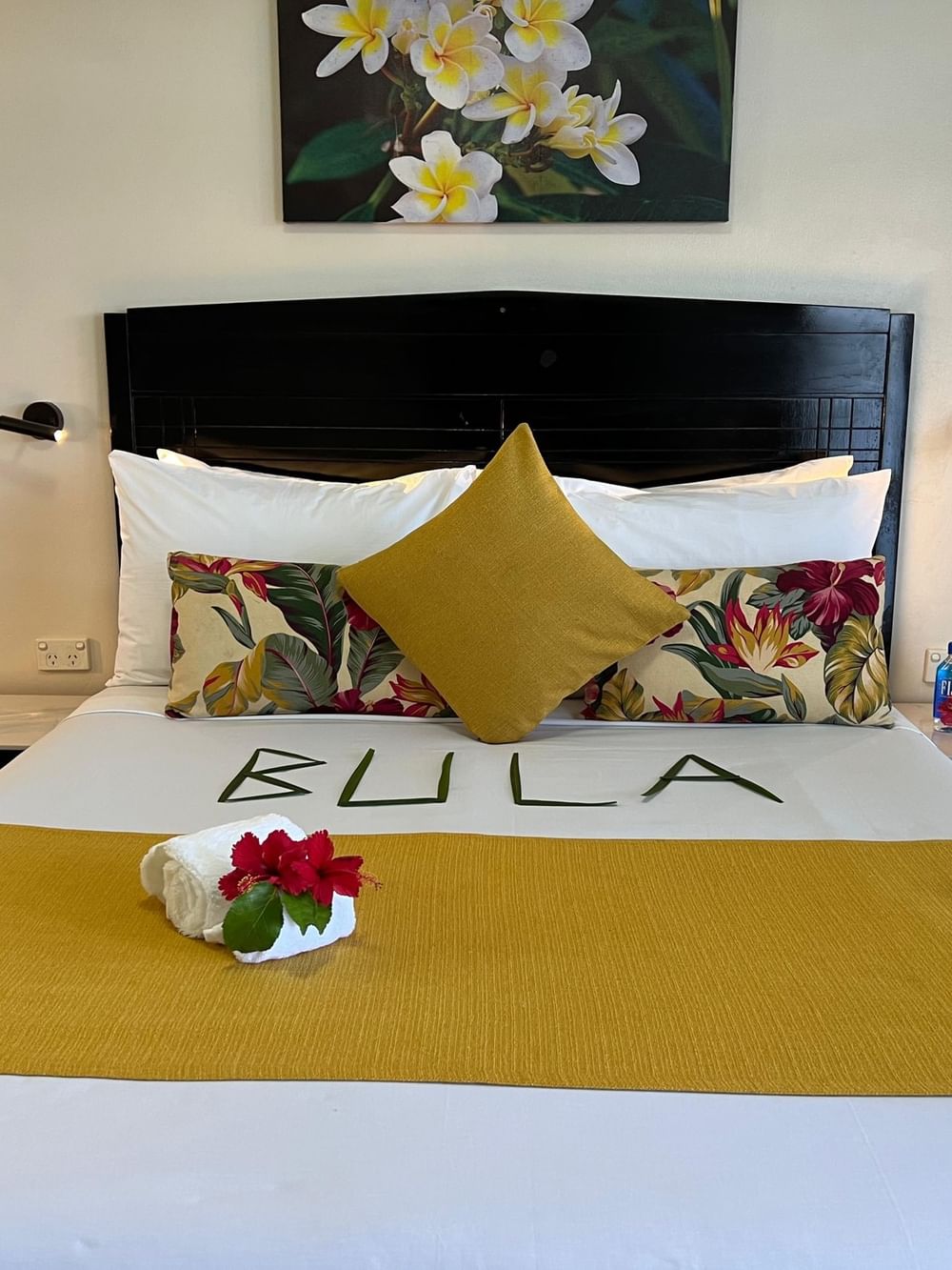 Cozy bed with tropical decor and amenities in a Standard Room at Tokatoka Resort Nadi.