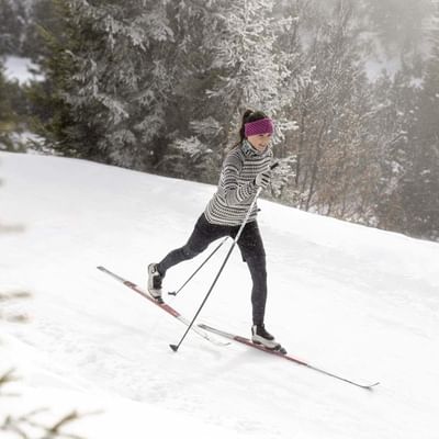 A girl doing cross-country skiing near Falkensteiner Hotels