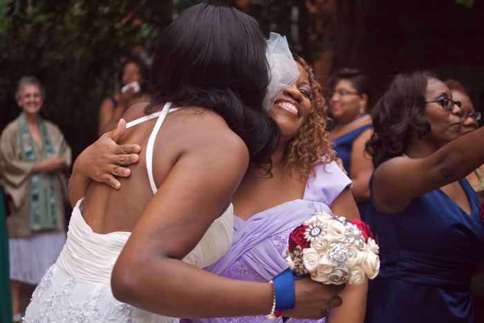 Bride hugging a woman at Kellogg Conference Center