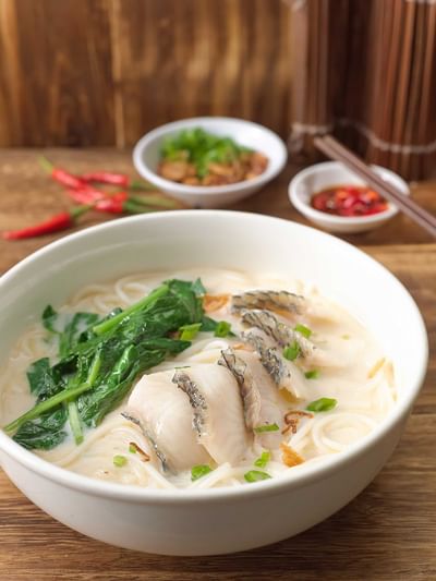 Gogi-guksu served on wooden table in White Rose Café at York Hotel Singapore