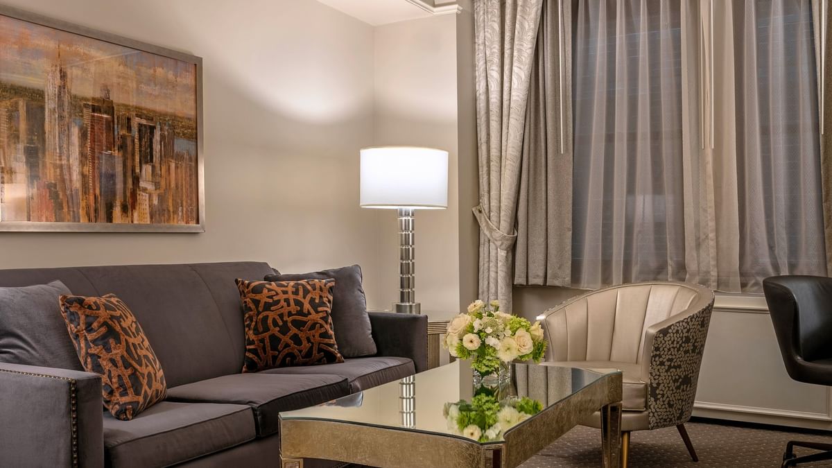 Premier Suite featuring plush sofa with floor lamp near window at Warwick New York