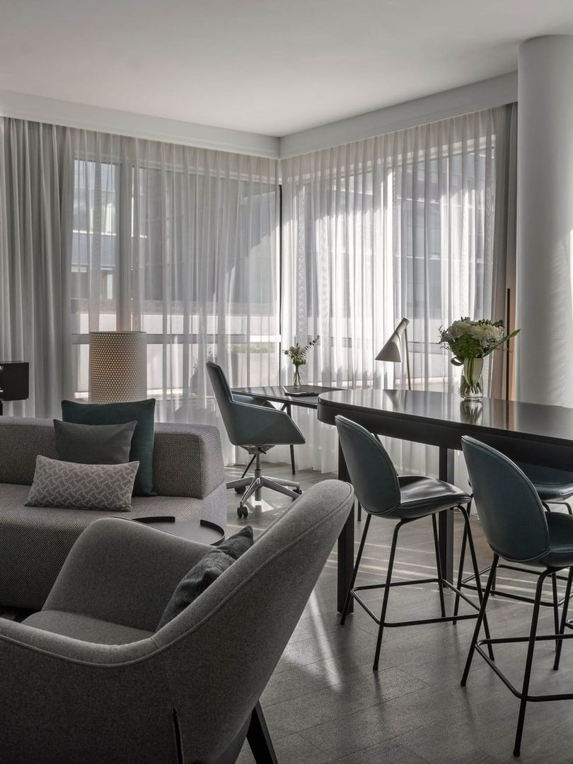 Penthouse René-Lévesque living area with plush sofa and bar counter near the window at Warwick Le Crystal Montreal