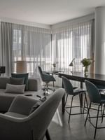 Penthouse René-Lévesque living area with plush sofa and bar counter near the window at Warwick Le Crystal Montreal