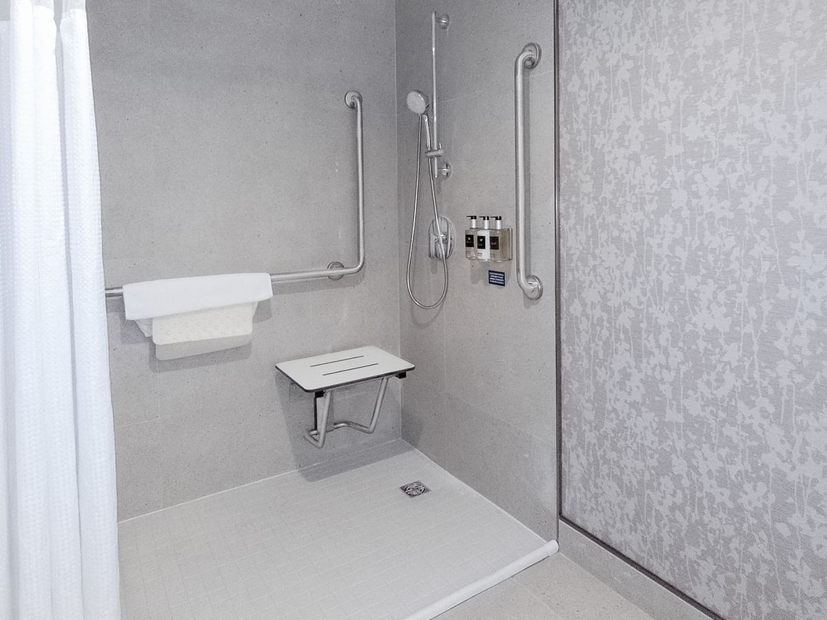 Hotel washroom with accessible roll-in shower