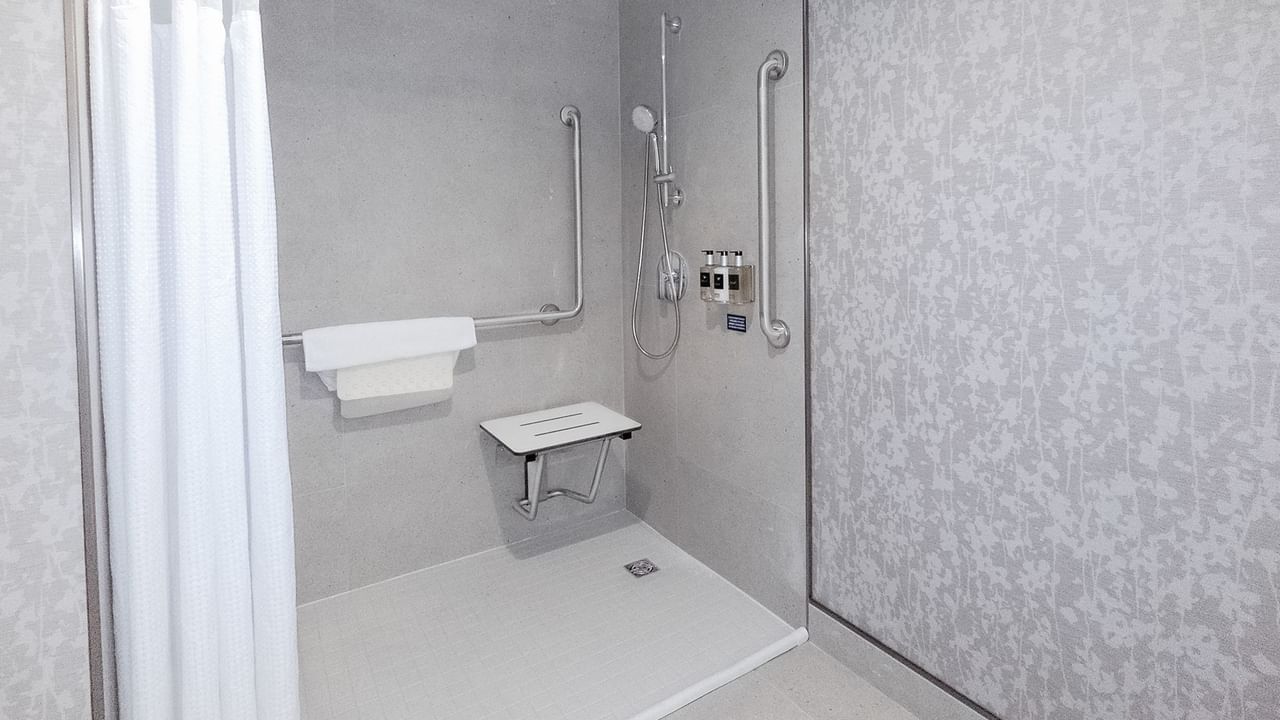 Hotel washroom with accessible roll-in shower