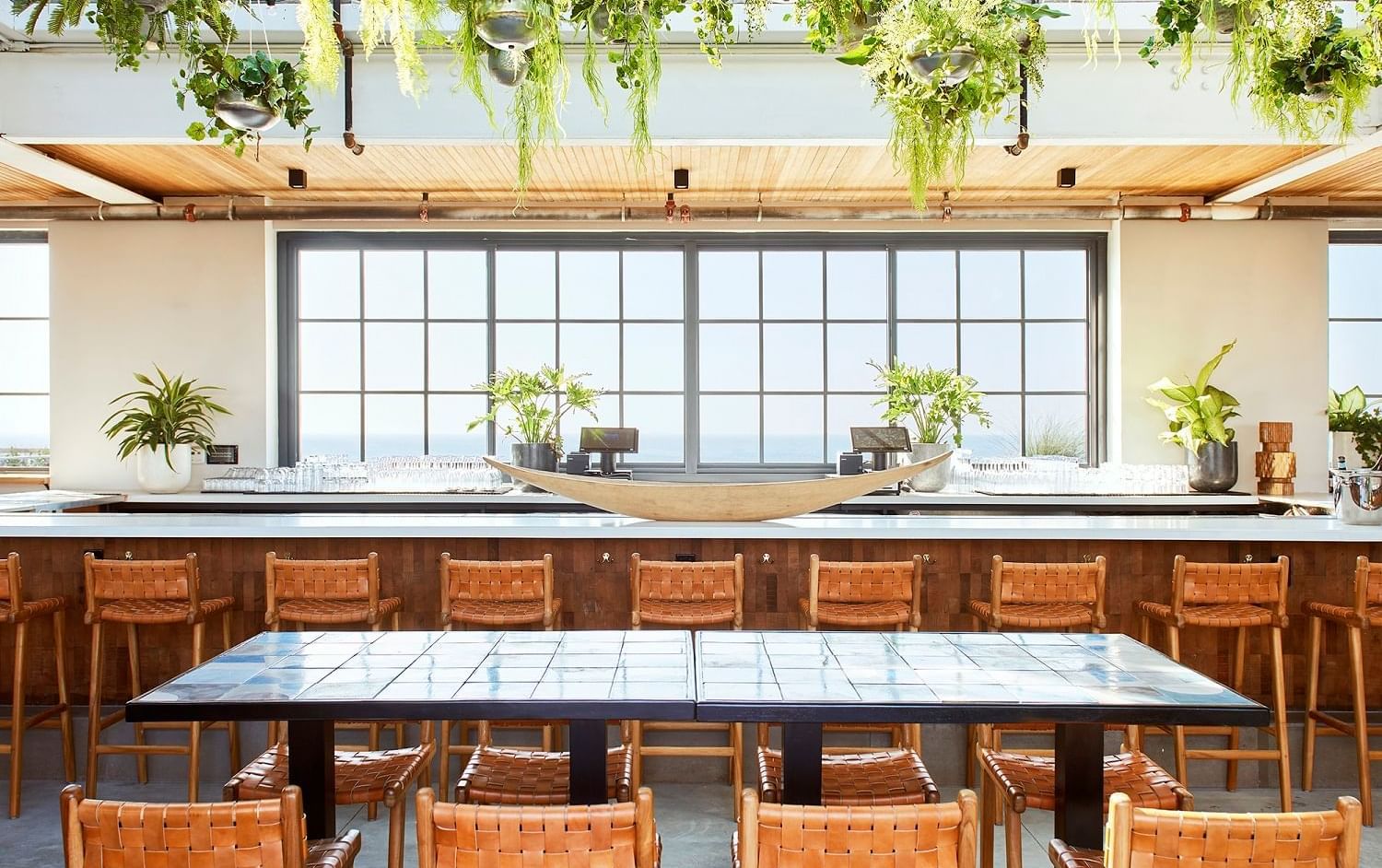 Bar counter & dining area at Rooftop bar in Rockaway Hotel