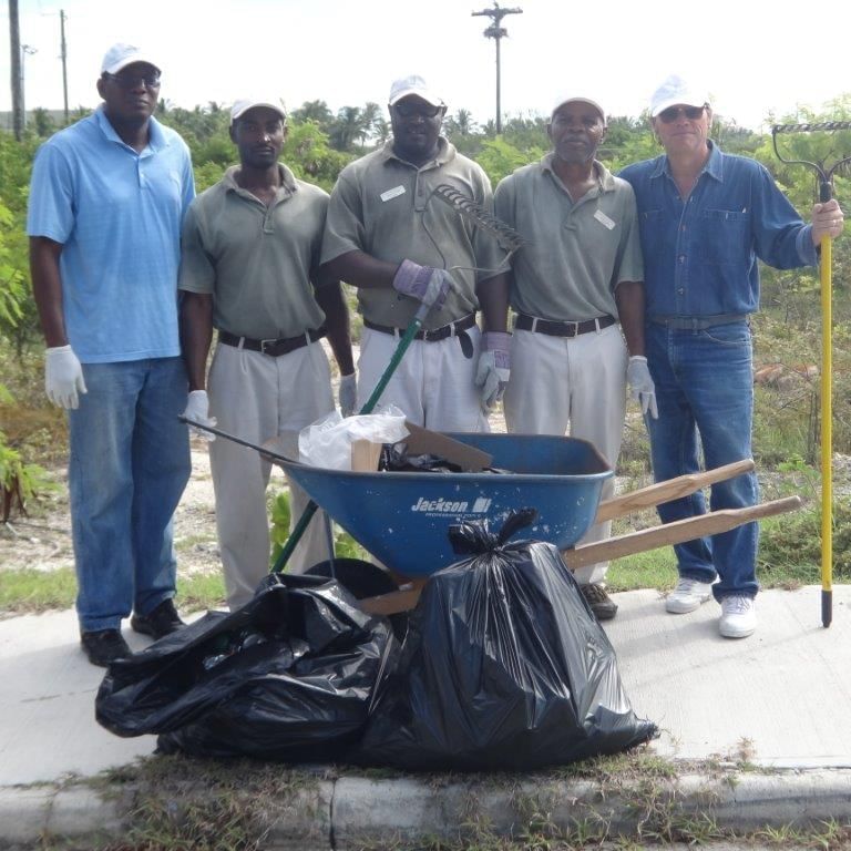 Collecting garbage in a wheel barrow, The Somerset On Grace Bay