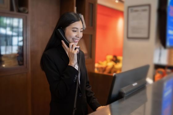 Close up of a Receptionist on a phone call at Federal Hotels