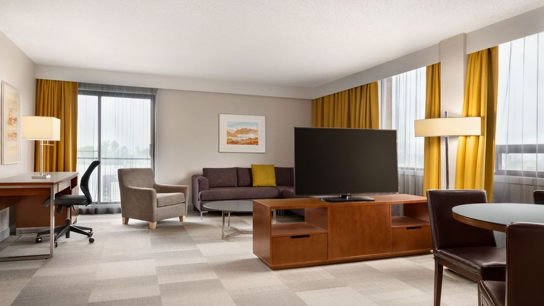Dining and living area of modern hotel suite