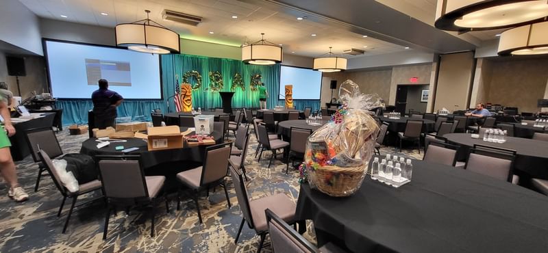 Large ballroom set up for an event with round tables and screens at Shangri-La Monkey Island resort