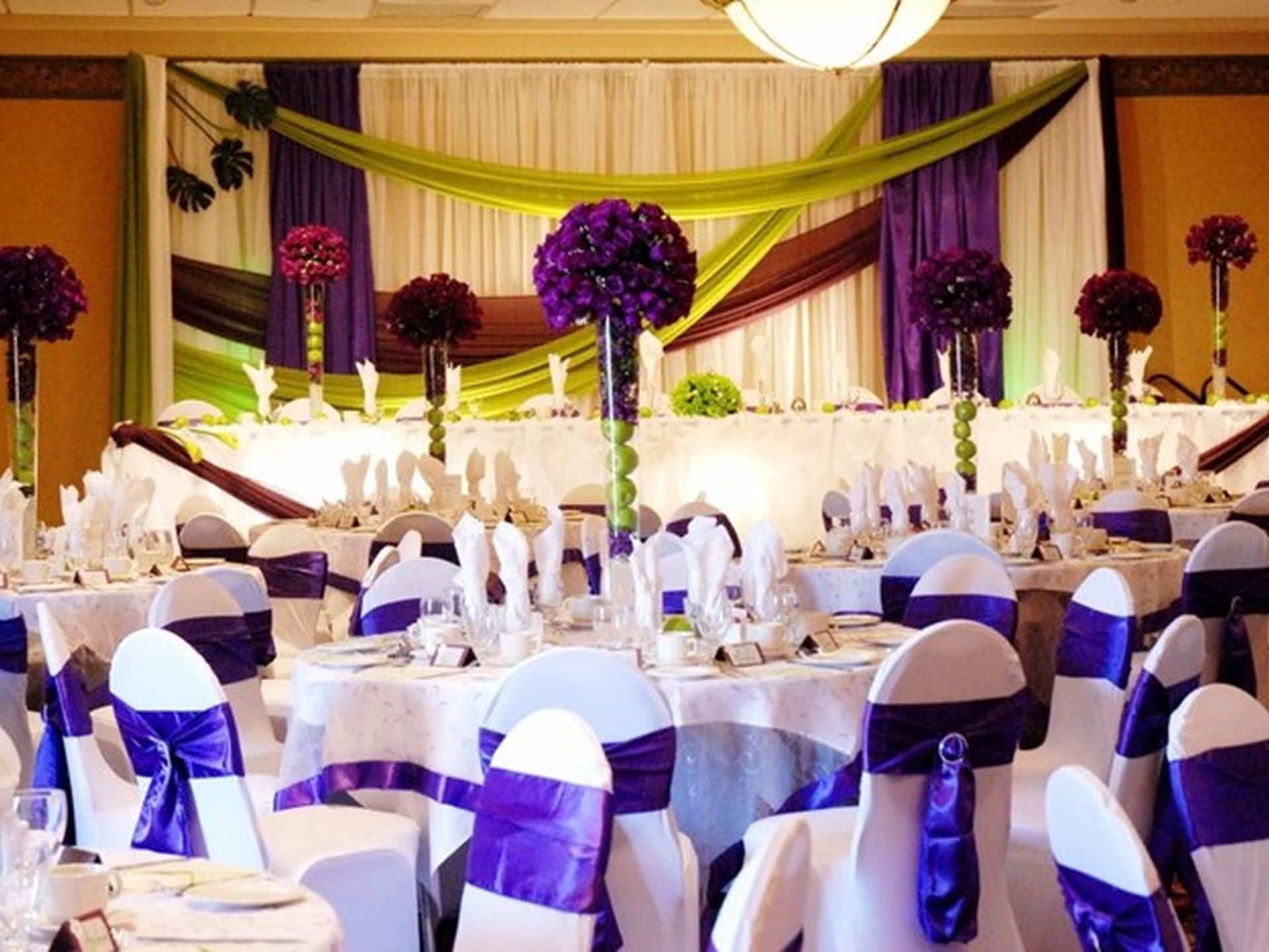 Banquet table set-up arranged for a wedding with floral decorations in an event room at The Glenmore Inn & Convention Centre