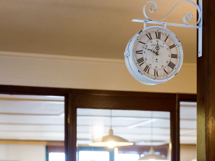 Closeup of a clock hanging in Hotel Annecy Aeroport