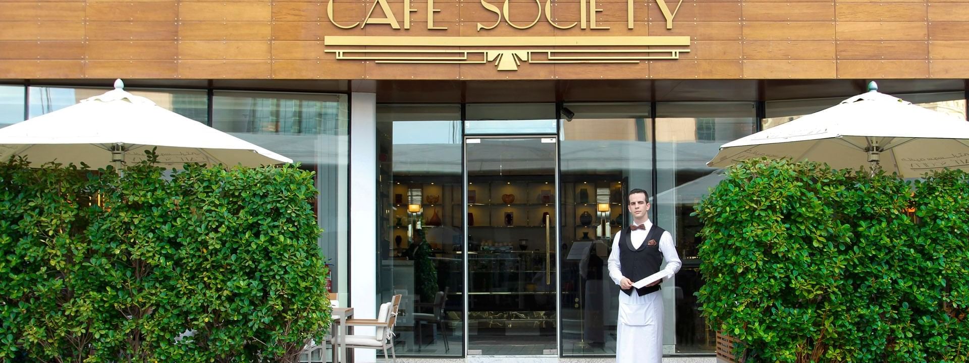 Entrance of cafe society with greeter at Tamani Marina Hotel
