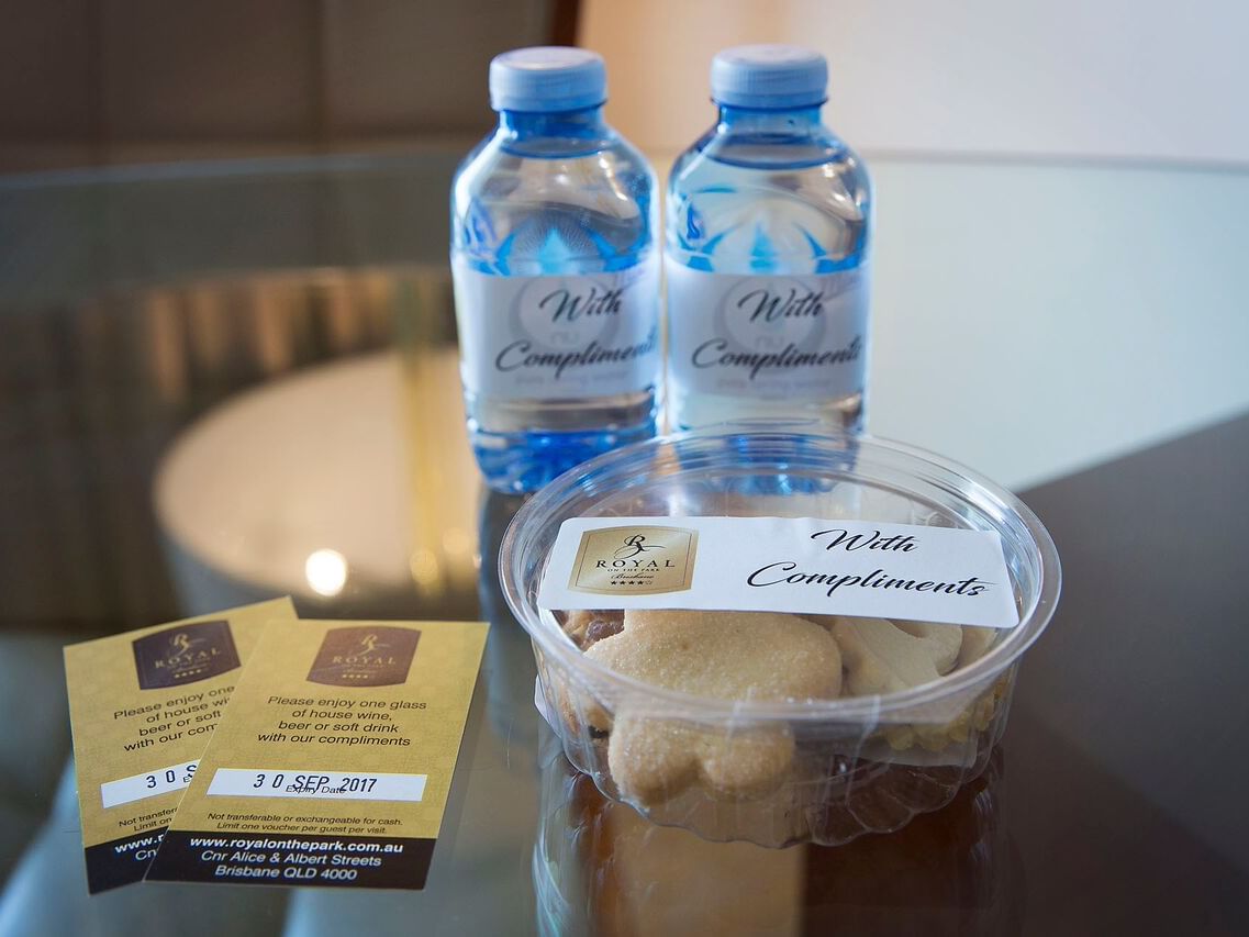 Two water bottles and snacks in Premium City View King Room at Royal on the Park hotel