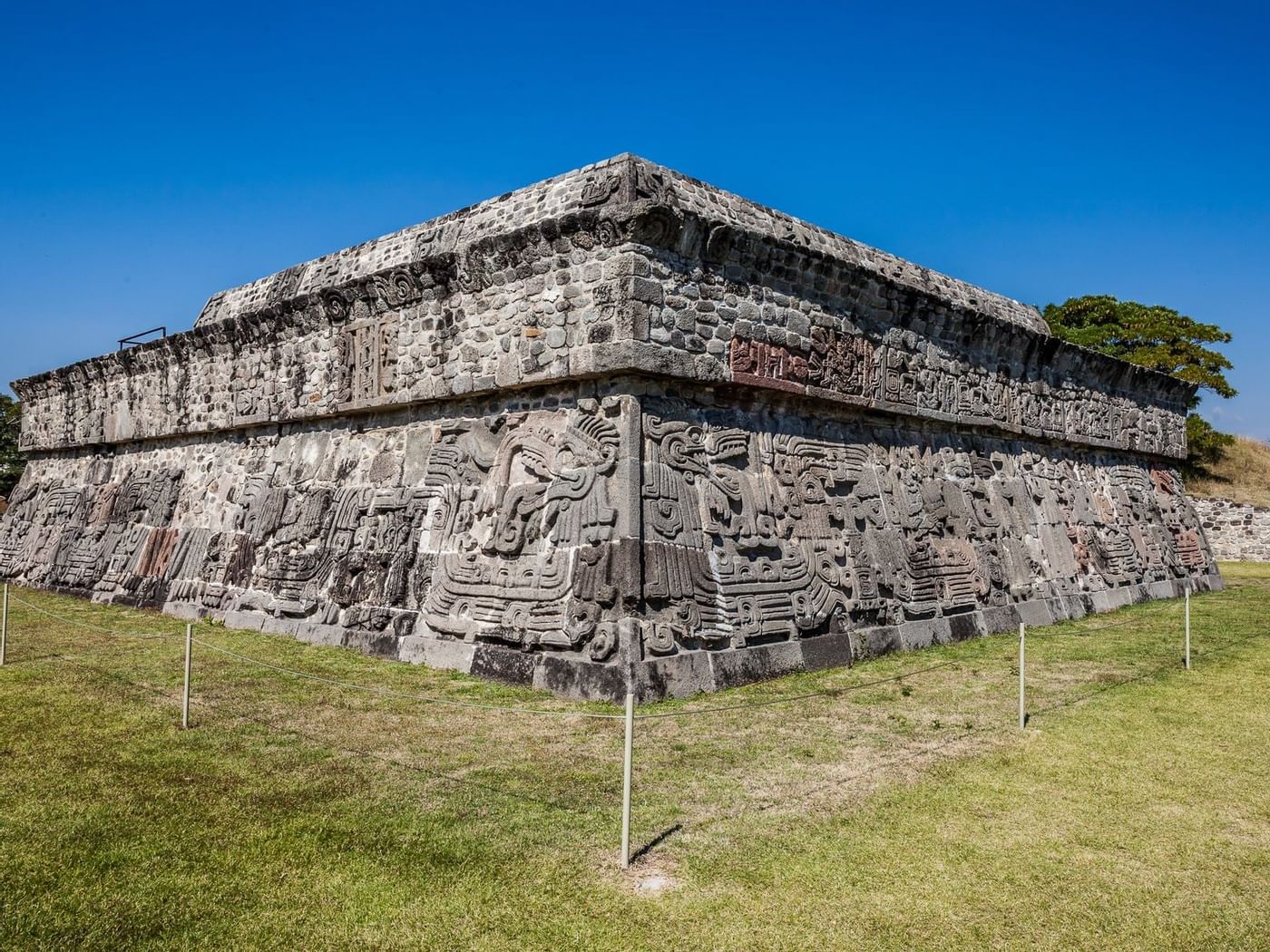 Un muro arqueológico con diseños cerca de Grand Fiesta Americana