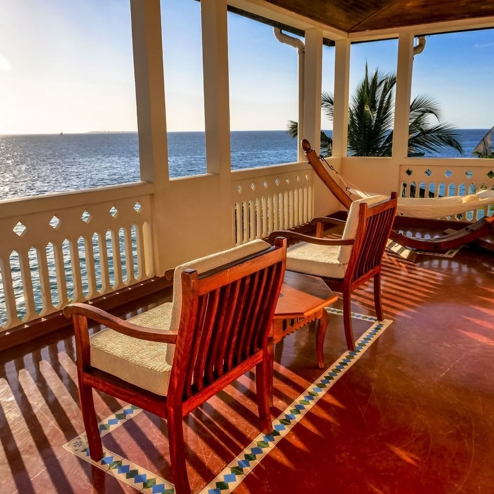 Ocean view from a balcony with chairs and hammock at Zanzibar Serena Hotel in Zanzibar.