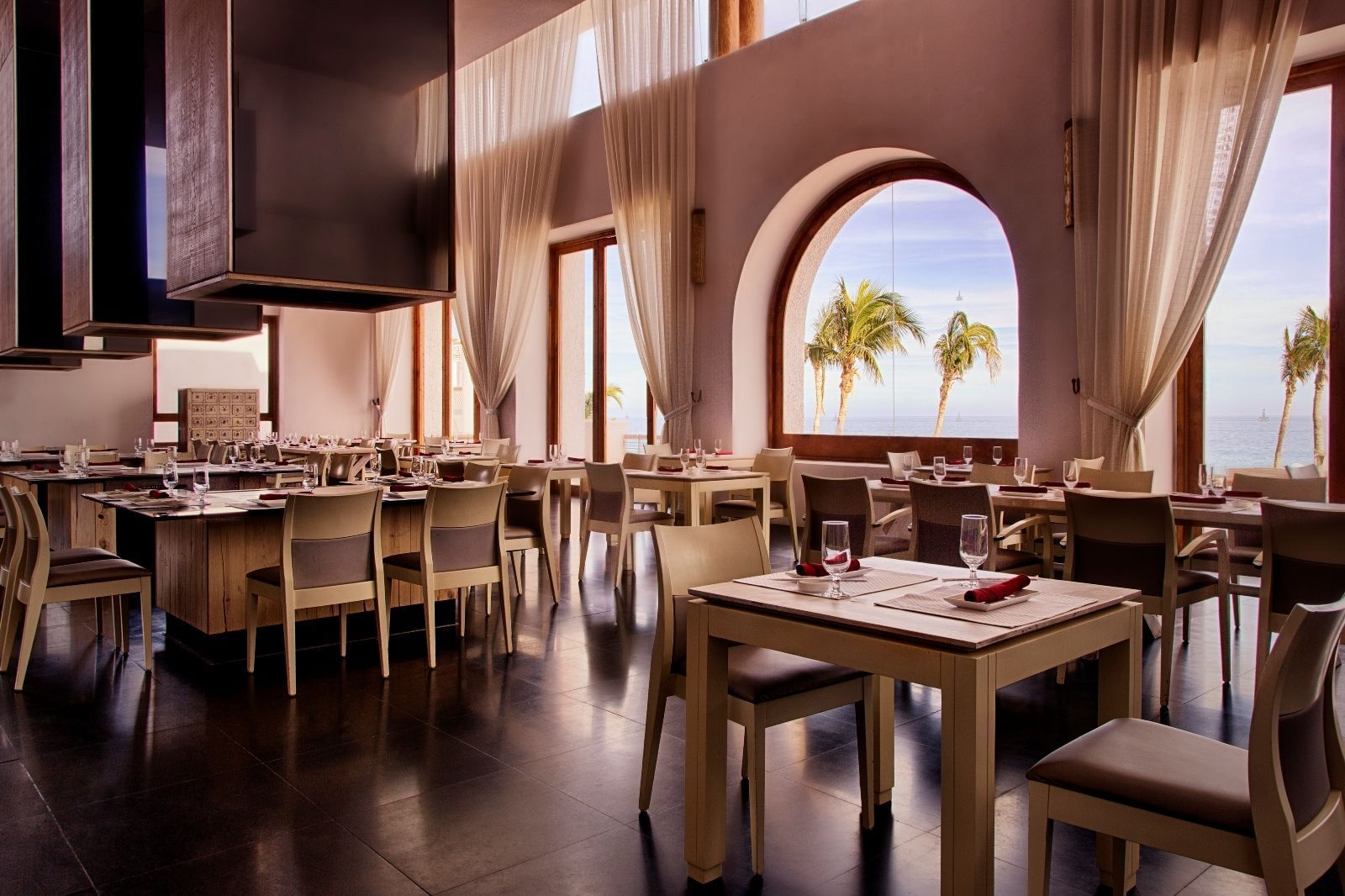 Chairs and tables in a dining area - Marquis Los Cabos 