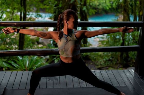 A girl in a yoga session in balcony of a room at Rio Celeste