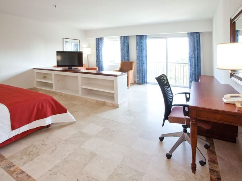 TV station, desk & balcony of the Master Suite at Gamma Hotels