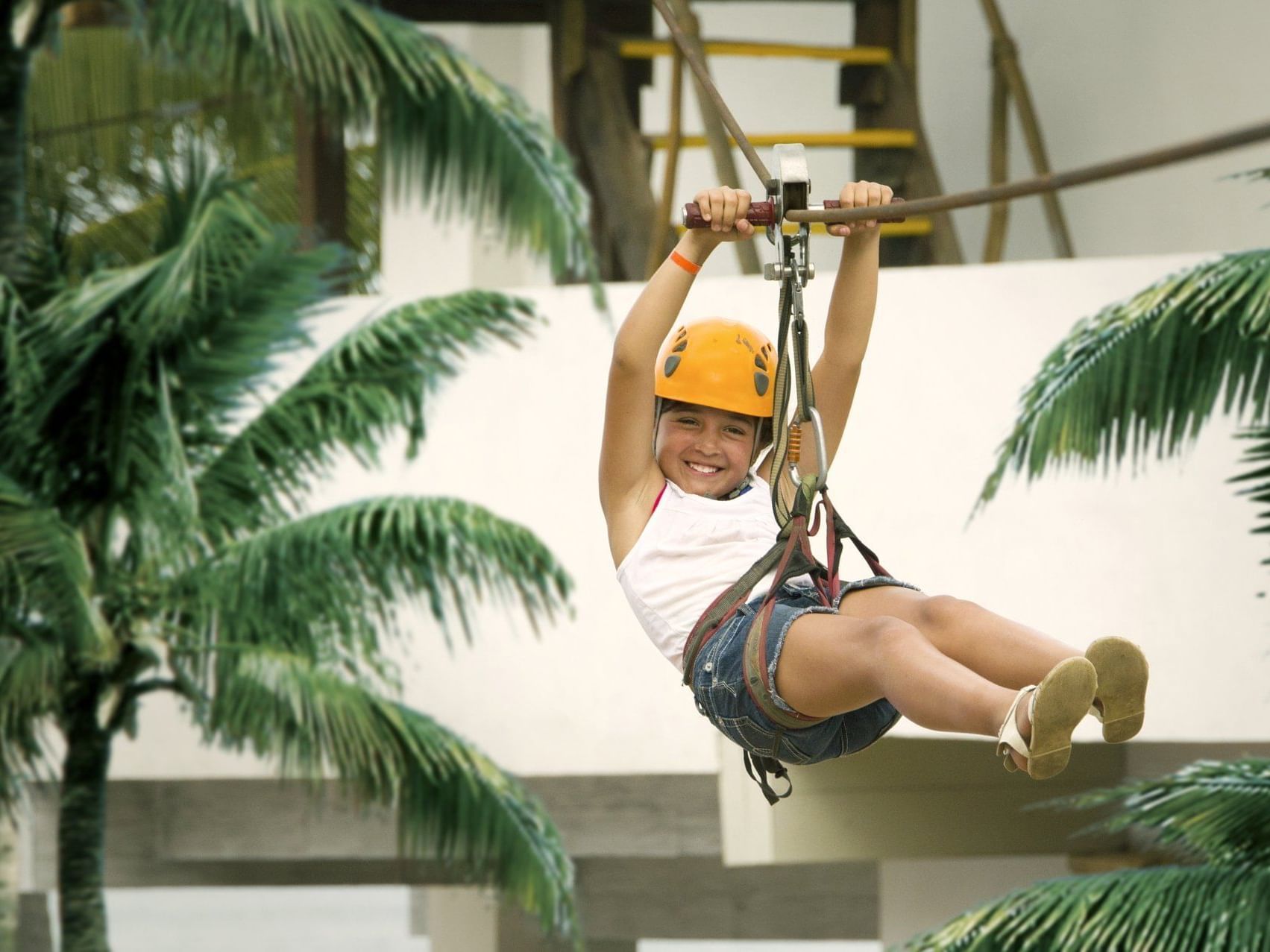 A Girl on a zip line at Crown Paradise Club